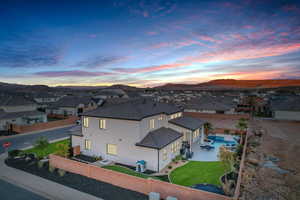 Aerial view at dusk of a residential view, view of pool area, and a mountain view