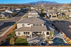 Aerial view of property and surrounding area with a mountainous background