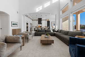 Living room featuring a towering ceiling and arched walkways