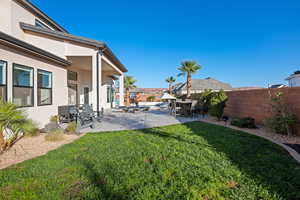 Fenced backyard with a patio