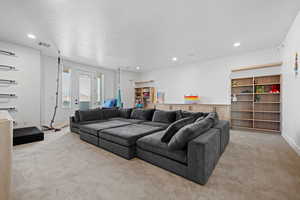 Living area featuring light carpet and recessed lighting