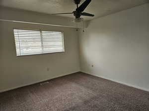 Master bedroom featuring a textured ceiling and ceiling fan