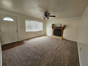 Large windows that flood the space with natural light, a cozy fireplace, and a ceiling fan for year-round comfort