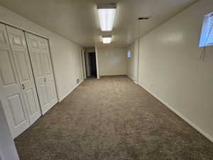 Finished basement Family Room featuring carpet and baseboards