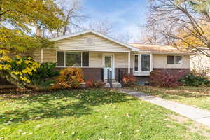 View of front of home featuring brick & siding