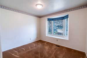 Bedroom featuring carpet and bay window