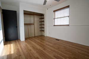 Second Bedroom (upstairs) window view shows wood flooring, a ceiling fan, and a closet with built in wood shelving