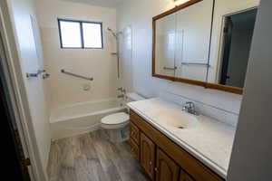 Primary Bathroom (upstairs) featuring vanity, laminate wood-type flooring, and bathtub shower combination