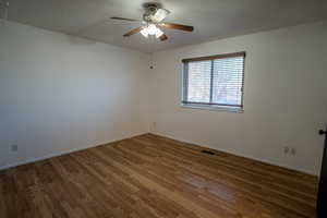 Primary Bedroom (upstairs) with light wood-style flooring, a textured ceiling, and ceiling fan