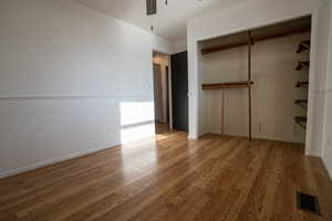 Second Bedroom (upstairs) featuring a ceiling fan, a closet, and wood flooring