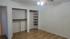 2nd bedroom with light wood finished floors and a ceiling fan