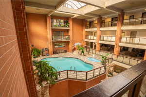 View of pool with a hot tub