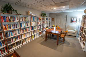 Carpeted home office with a drop ceiling