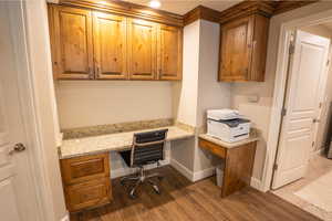 Office area featuring built in study area and dark wood-type flooring