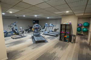 Exercise room with carpet, recessed lighting, and a drop ceiling