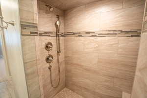 Full bathroom featuring a shower stall