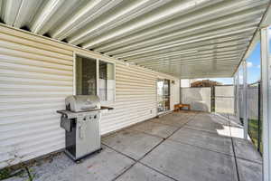 View of patio with a grill