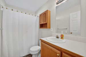 Full bathroom featuring a shower with curtain and vanity