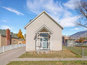 View of property exterior with stucco siding and a mountain view