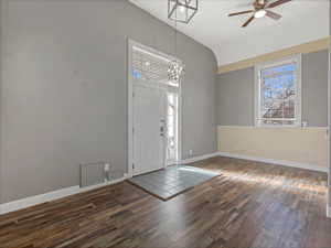 Entryway with dark wood-style floors, plenty of natural light, ceiling fan, and a wainscoted wall