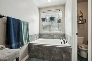 Bathroom with a bath and toilet