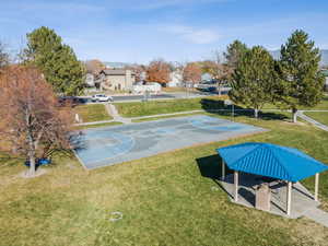 View of basketball court with a yard, community basketball court, and a patio area