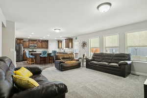 Living area featuring dark carpet and recessed lighting