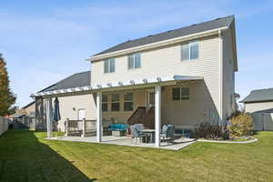 Rear view of house with a patio area, a shed, roof with shingles, and a pergola