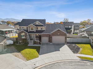 Traditional home featuring a porch, concrete driveway, roof with shingles, and a residential view