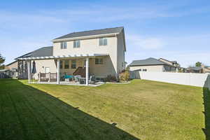 Back of property featuring a pergola and a patio