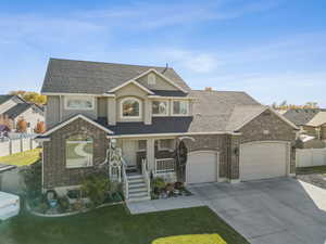 View of front of property with a porch, concrete driveway, a garage, brick siding, and a shingled roof