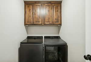Laundry area featuring cabinet space and washer and dryer