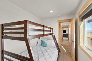 Bedroom with light carpet and recessed lighting