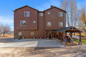 Back of house with faux log siding