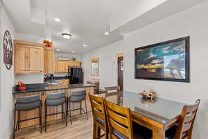 Dining space with recessed lighting and light wood finished floors
