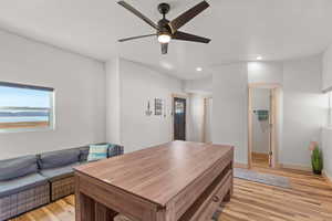Office featuring light wood finished floors, recessed lighting, and a ceiling fan