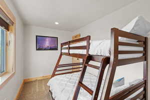 Carpeted bedroom with baseboards and recessed lighting