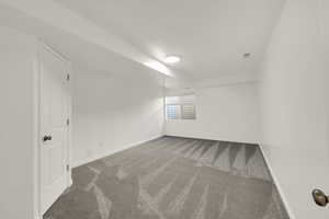 Unfurnished room featuring light colored carpet and baseboards