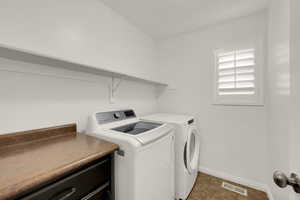 Laundry room featuring baseboards and independent washer and dryer