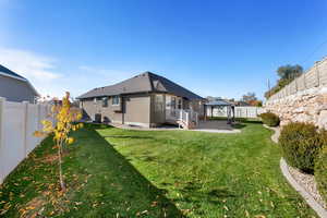 Rear view of property featuring a fenced backyard, a gazebo, a patio area, and stucco siding