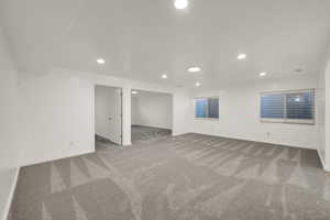 Below grade area featuring light carpet and recessed lighting