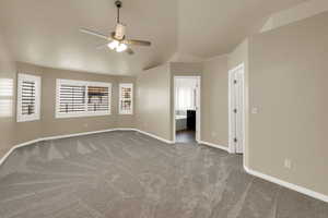 Unfurnished room featuring carpet, vaulted ceiling, and ceiling fan