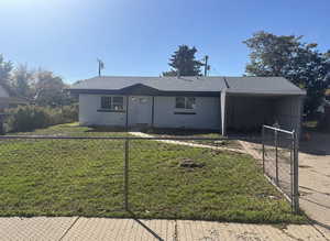 Ranch-style house with brick siding, an attached carport, and a shingled roof