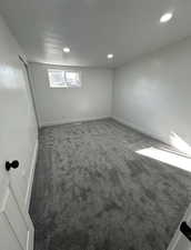 Unfurnished room featuring carpet, a textured ceiling, and recessed lighting
