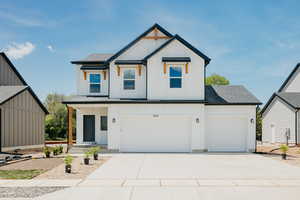 Modern farmhouse style home featuring board and batten siding, a shingled roof, driveway, covered porch, and an attached garage