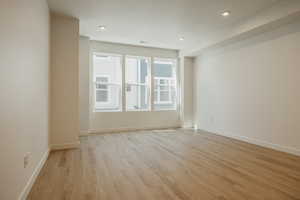 Unfurnished room with light wood finished floors and recessed lighting