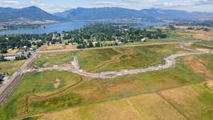 Aerial view of property and surrounding area featuring a water and mountain view