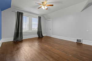 Bonus room featuring ceiling fan, vaulted ceiling, and dark wood finished floors