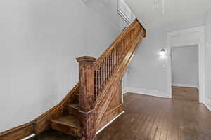 Staircase featuring wood-type flooring and baseboards