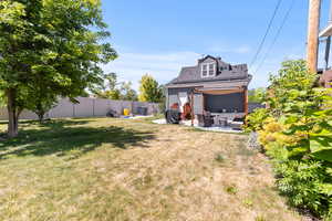 Fenced backyard with a patio and outdoor seating
